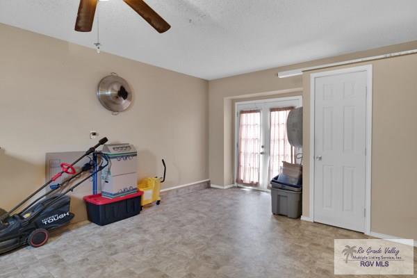 game room featuring tile patterned floors, a ceiling fan, and baseboards