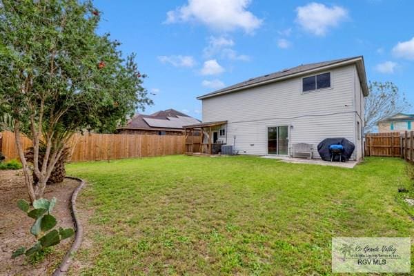 rear view of property featuring a yard, a patio, a fenced backyard, and central air condition unit