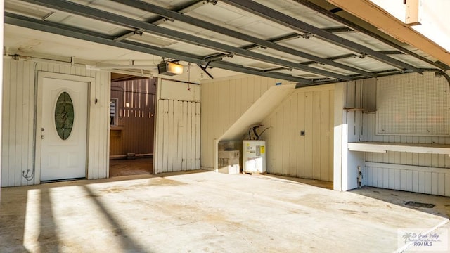 garage featuring a garage door opener and electric water heater