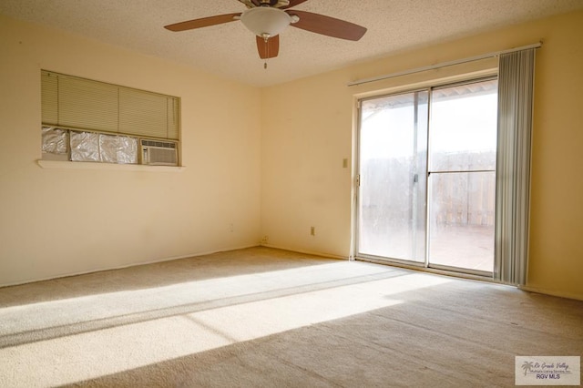 unfurnished room featuring a textured ceiling, carpet floors, and ceiling fan