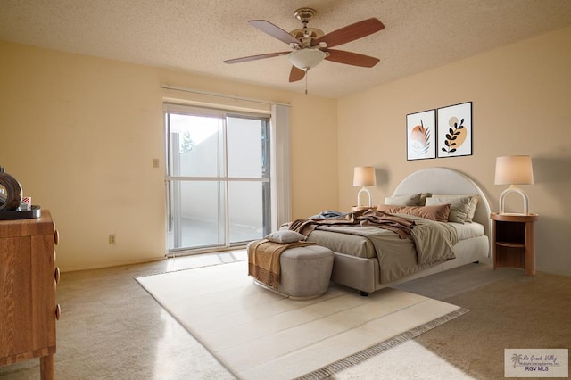 bedroom with a ceiling fan, access to outside, light carpet, and a textured ceiling