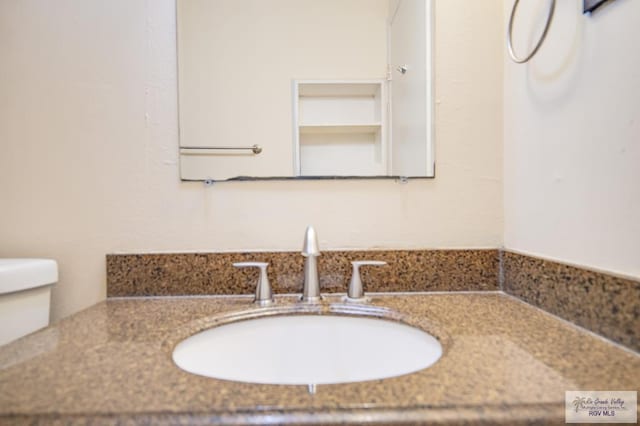 bathroom featuring vanity and toilet