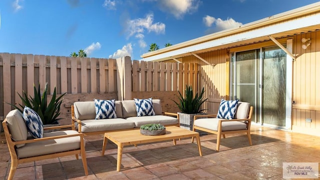 view of patio / terrace featuring an outdoor hangout area and fence