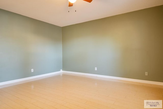 unfurnished room with light wood finished floors, ceiling fan, and baseboards