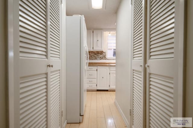 hallway with light wood-style floors