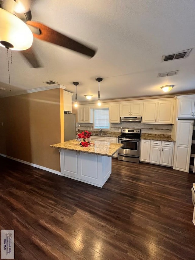 kitchen with sink, stainless steel appliances, light stone counters, pendant lighting, and white cabinets