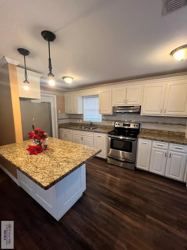 kitchen with light stone counters, dark hardwood / wood-style floors, decorative light fixtures, white cabinets, and appliances with stainless steel finishes