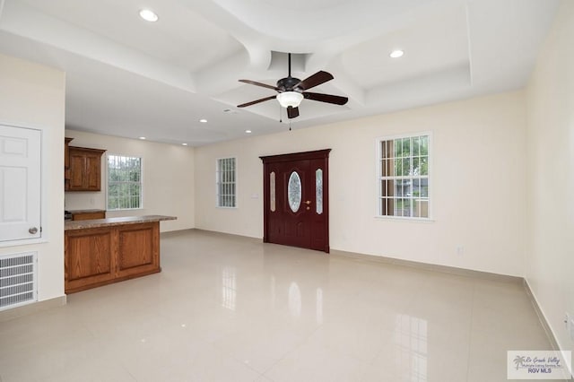 interior space with beamed ceiling, ceiling fan, and light tile patterned flooring