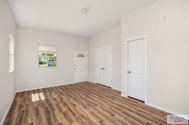 empty room with dark hardwood / wood-style flooring