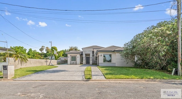 47 Medical St, Brownsville, TX 78520 - view of front of property featuring stucco siding, driveway, and a tiled roof