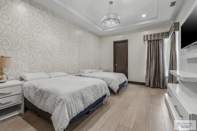 47 Medical St, Brownsville, TX 78520 - bedroom featuring a tray ceiling, a chandelier, light wood-type flooring, recessed lighting, and baseboards