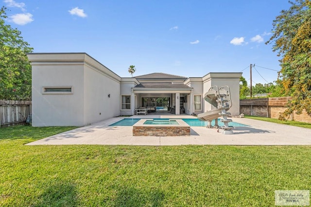47 Medical St, Brownsville, TX 78520 - rear view of property featuring a patio, stucco siding, and a pool with connected hot tub