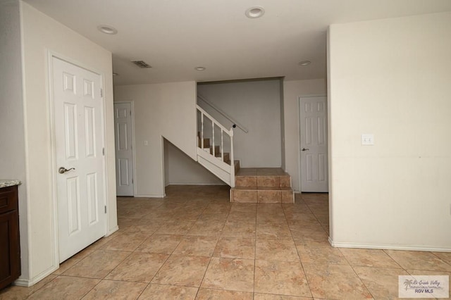 hallway featuring light tile patterned floors