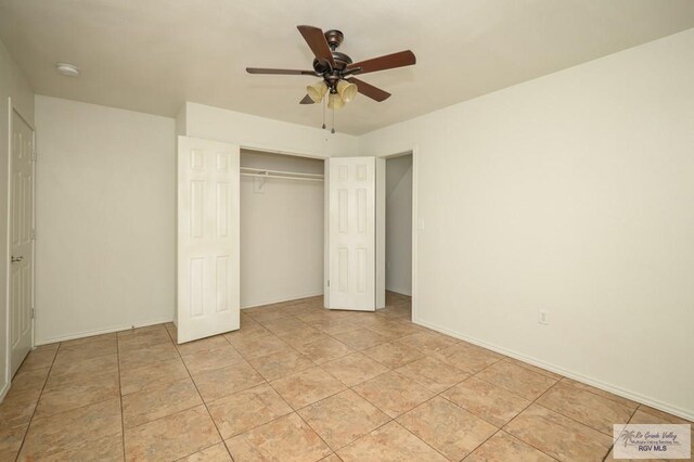 unfurnished bedroom with ceiling fan, a closet, and light tile patterned floors