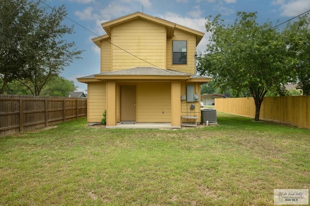 rear view of house featuring a yard, a patio, and central AC