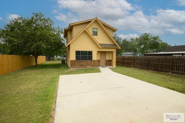 view of front facade featuring a front yard and a patio