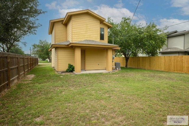 back of house featuring a patio, cooling unit, and a lawn