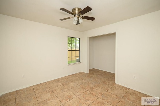 tiled empty room with ceiling fan