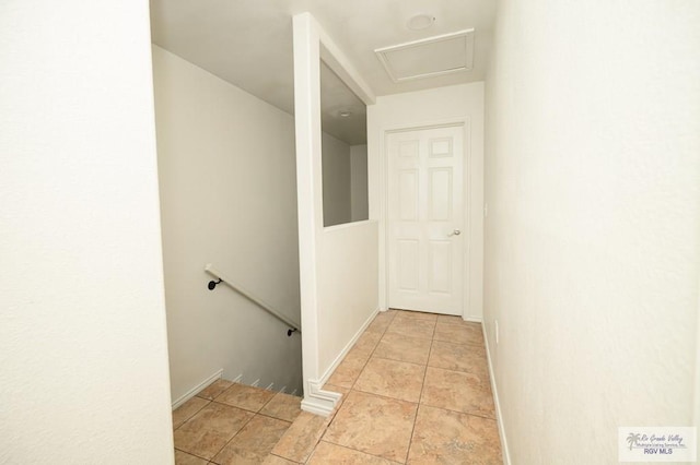 hall with light tile patterned floors