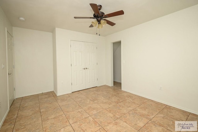 unfurnished bedroom with ceiling fan, light tile patterned flooring, and a closet