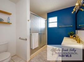 4515 Graham Rd Unit 4, Harlingen, TX 78552 - bathroom featuring vanity, a shower with shower door, and tile patterned floors