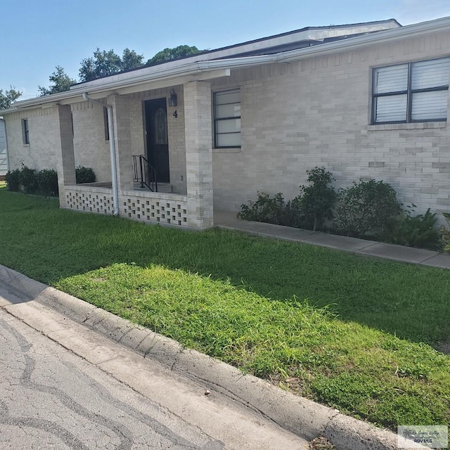 4515 Graham Rd Unit 4, Harlingen, TX 78552 - view of front of home with a front yard, brick siding, and a porch