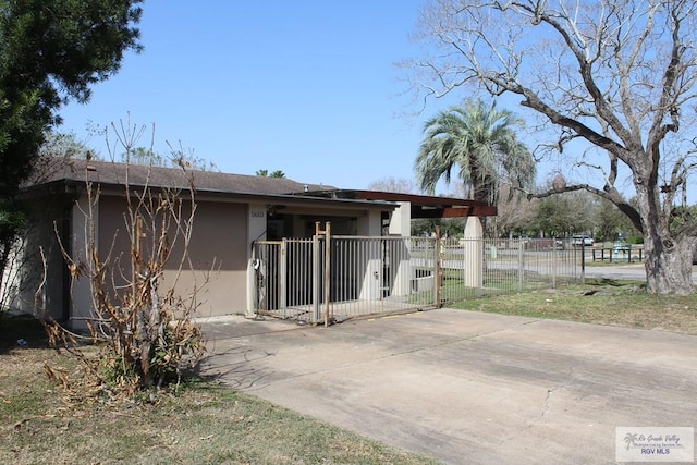 exterior space with fence, a patio, and stucco siding