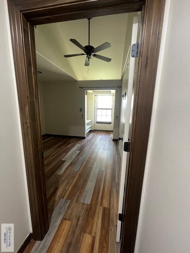 hall featuring dark wood-style floors and baseboards