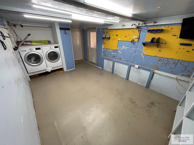 basement featuring separate washer and dryer and a workshop area