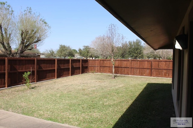 view of yard with a fenced backyard