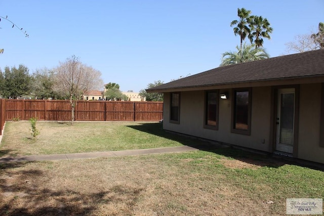 view of yard with a fenced backyard