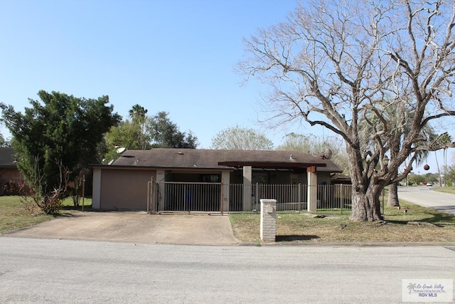 view of front of house featuring concrete driveway, a fenced front yard, and stucco siding