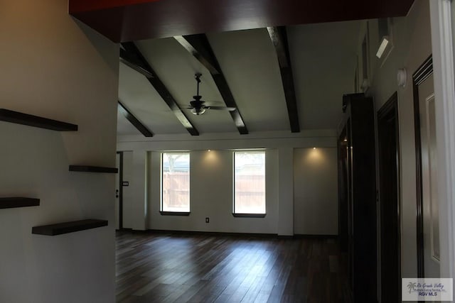 interior space with a ceiling fan, dark wood finished floors, and lofted ceiling with beams