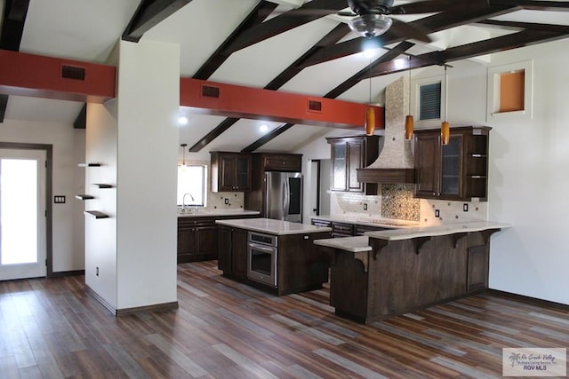 kitchen with tasteful backsplash, light countertops, appliances with stainless steel finishes, glass insert cabinets, and dark brown cabinetry