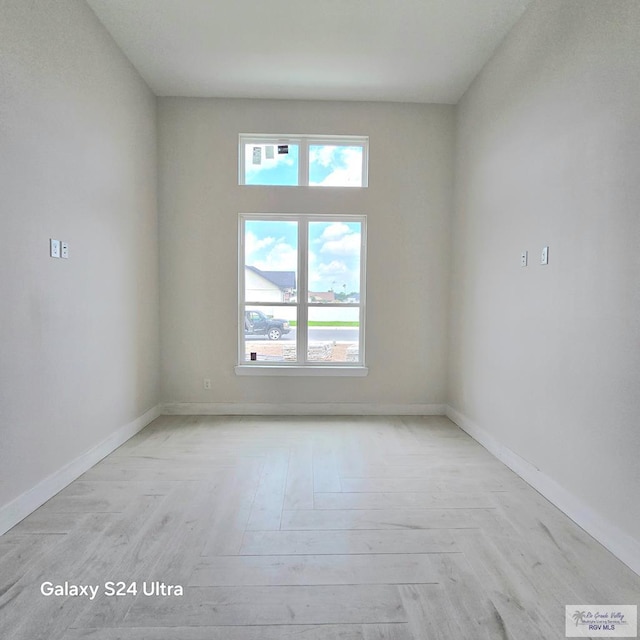 1309 Thacker Ln, Harlingen, TX 78552 - empty room with baseboards, healthy amount of natural light, and light wood-type flooring
