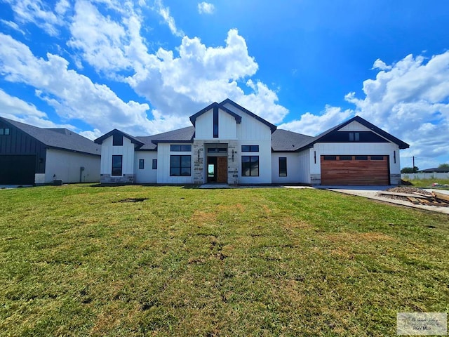 1309 Thacker Ln, Harlingen, TX 78552 - modern farmhouse with board and batten siding, a garage, a front lawn, and concrete driveway