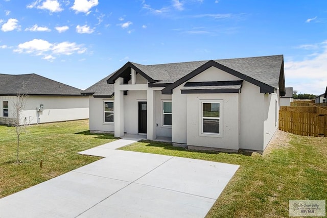 view of front of home with a patio and a front yard