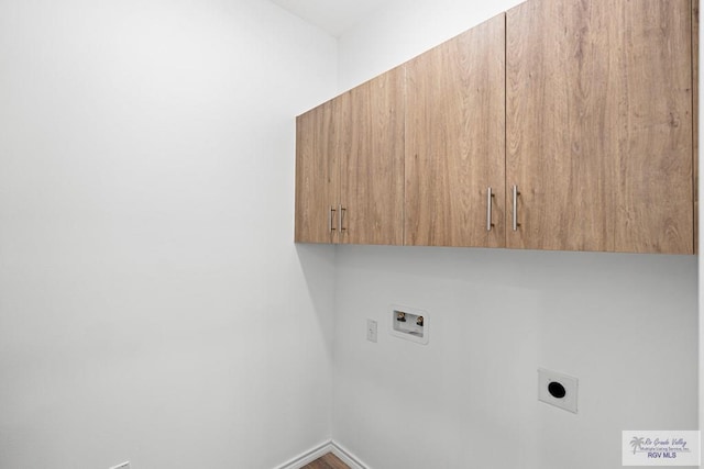 clothes washing area with electric dryer hookup, cabinets, and hookup for a washing machine