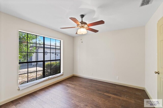 spare room featuring ceiling fan and dark wood-type flooring