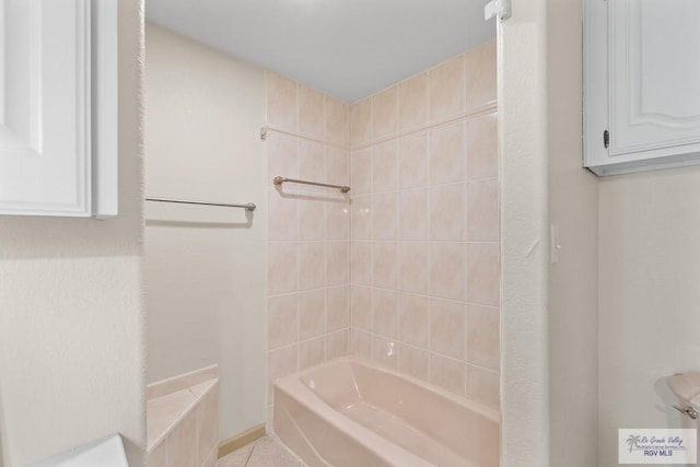 bathroom with tile patterned floors and tiled shower / bath