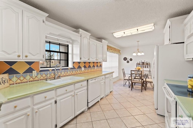 9 Sunshine Pl, Brownsville, TX 78526 - kitchen featuring white appliances, white cabinetry, and a textured ceiling