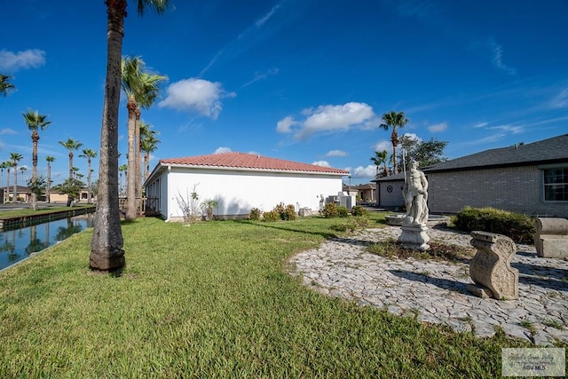 9 Sunshine Pl, Brownsville, TX 78526 - view of grassy yard featuring a water view