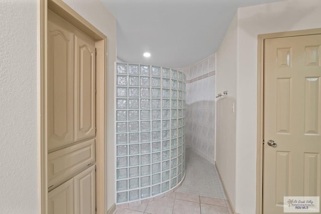 bathroom featuring tile patterned floors and tiled shower