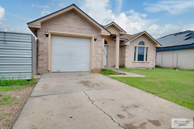 view of front of house featuring a garage and a front yard