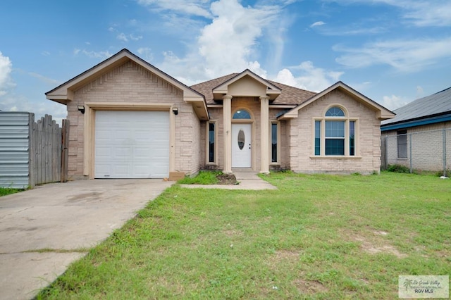 ranch-style house featuring a garage and a front yard