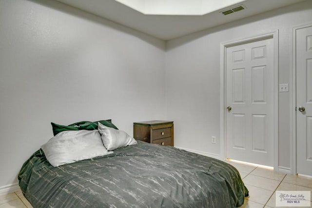 bedroom with light tile patterned flooring