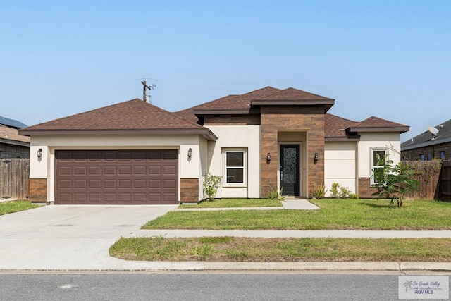 view of front facade featuring a front yard and a garage