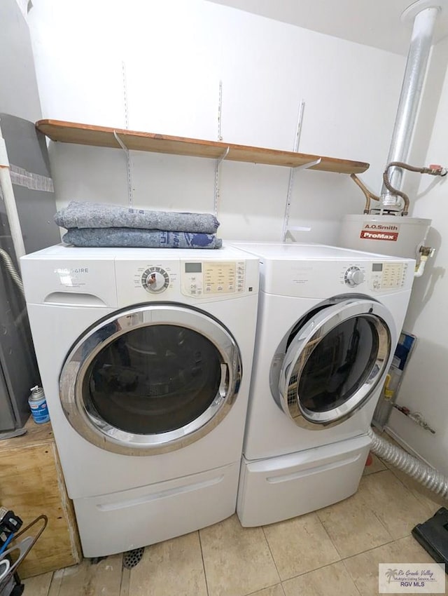 laundry area with light tile patterned flooring and washing machine and clothes dryer