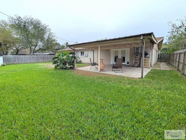 back of property featuring a lawn and a patio