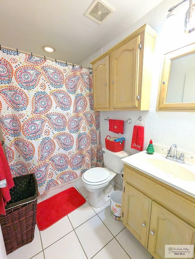 bathroom with a shower with curtain, tile patterned flooring, vanity, and toilet